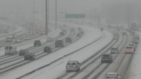 Toronto, Ontario, Canada February 2018 Cars and trucks driving on highway 401 in heavy snow in Toronto winter storm