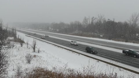 Ontario, Canada February 2018 Cars and trucks driving on the highway in heavy snow during winter storm