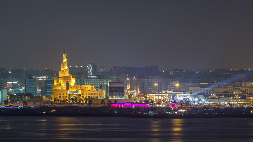 Doha skyline with the Islamic Cultural Center timelapse illuminated by night in Qatar, Middle East. View from top of building on west bay