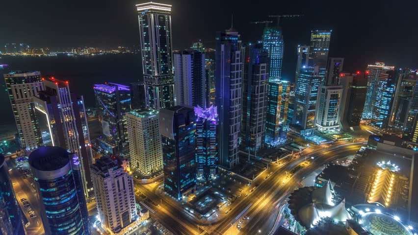 The skyline of the West Bay area from top in Doha timelapse, Qatar. Illuminated modern skyscrapers aerial view from rooftop at night. Traffic on the road | Shutterstock HD Video #1007434543