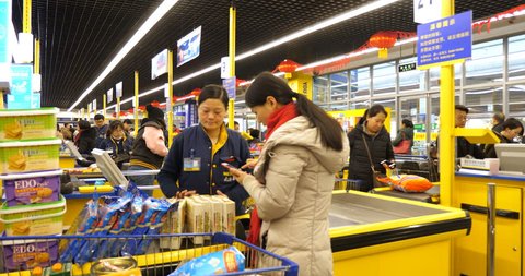 February 12, 2018 in Chengdu, Sichuan China . people settle the bill with mobile phone in the Metro supermarket, people use mobile phone to pay almost everything in China now days,mobile payment