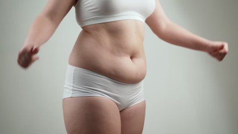 Woman in white underwear holds her belly fat. Stock Video Footage