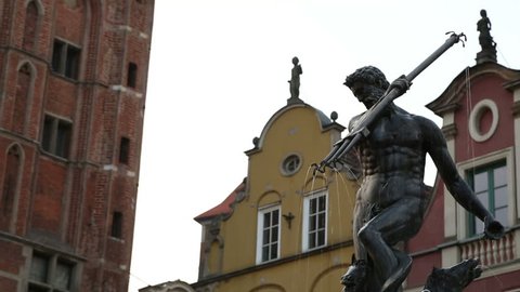 Sculptures adorning fountain in city, statue of Poseidon holding trident, Gdansk