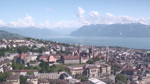 Lausanne Switzerland iconic view aerial shot / Beautiful aerial panorama of Lausanne, with cathedral, lake and mountains in the background