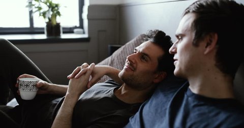 Young male couple relaxing with coffee Video stock