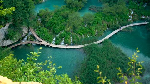 Beautiful board walk on waterfall cascade of Plitvice Lakes in Croatia. Nature landscape of Plitvice Lakes National Park is the UNESCO World Heritage in natural mountain Karst area of central Croatia.