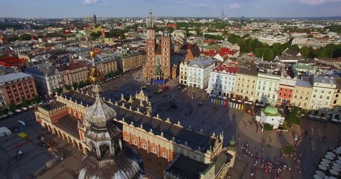 Cracow Main Squere. Camera is going down along the city hall tower. Medival old town in Europe. Drone footage shoot in 4K.