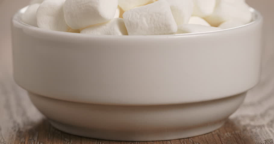 white marshmallows in white bowl on table