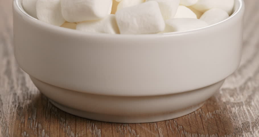 white marshmallows in white bowl on table
