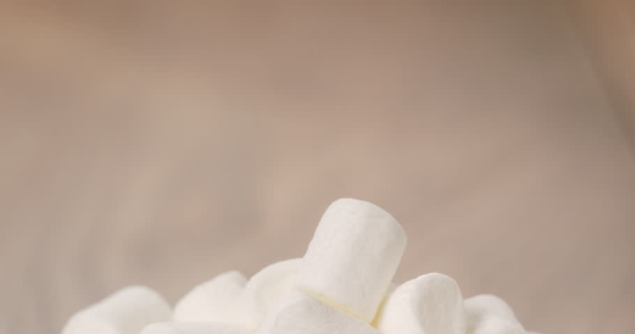 white marshmallows in white bowl on table