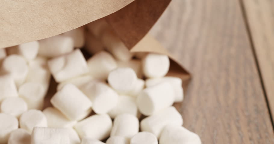 marshmallow in brown craft paper bag on wooden table