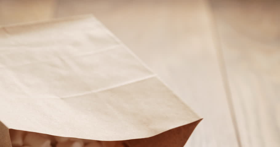 marshmallow in brown craft paper bag on wooden table