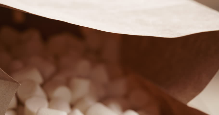 marshmallow in brown craft paper bag on wooden table