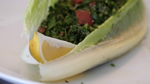 Tabbouleh salad Tabouli Recipe chopped parsley, mint, bulgur and half a lemon in a lettuce