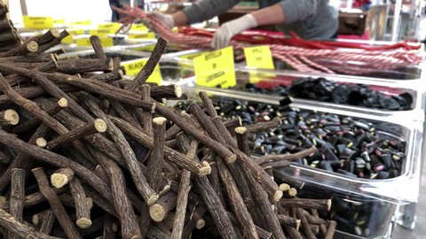 Tasty licorice sticks and roots in a stall. Close up. sweet food.