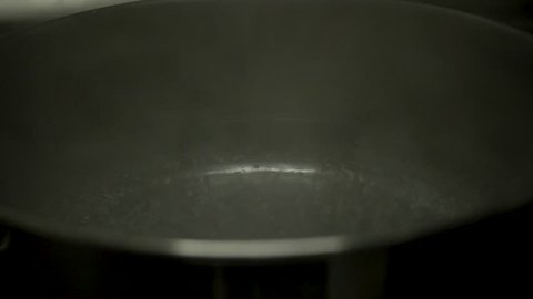 Salt falling into simmering water (Slow motion)