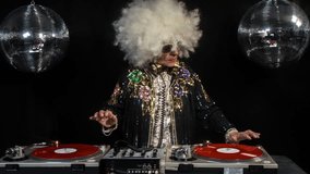 the coolest grandma ever in huge wig, older woman djing and partying in a disco setting. this version has overlayed video distortion and glitch effects