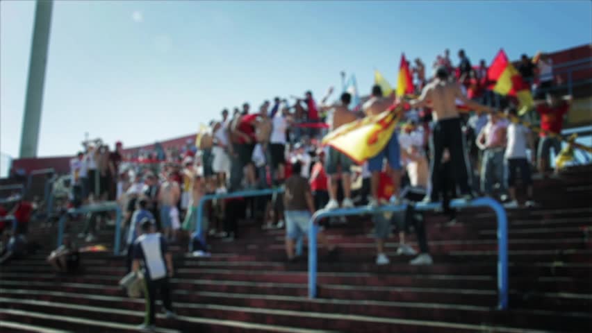 Blurred Passionate Soccer Fans Waving Flags in Argentine Stadium