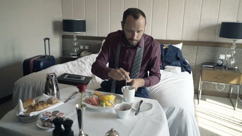 Businessman drinking coffee during breakfast in hotel
