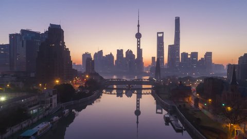 Panoramic Shanghai Skyline Silhouette at Dawn. Lujiazui Financial District and Huangpu River. China. Aerial Hyper Lapse. Drone is Flying Upward and Forward. Establishing Shot.
