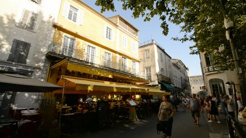 ARLES, FRANCE - 7TH JULY 2017: Tourists in the street and Van Gogh restaurant in the Arles, Provence, France, Europe.
