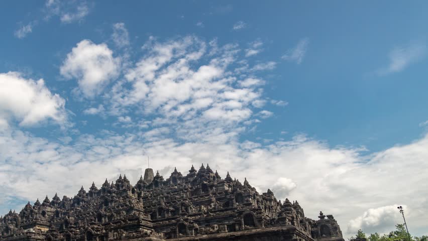 Time Lapse of Heritage Buddist temple Borobudur complex in Yogjakarta in Java, indonesia. Tilt from right.