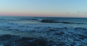 Aerial View of Waves, Foaming and Splashing in the Ocean, sunset, Slow Motion Video