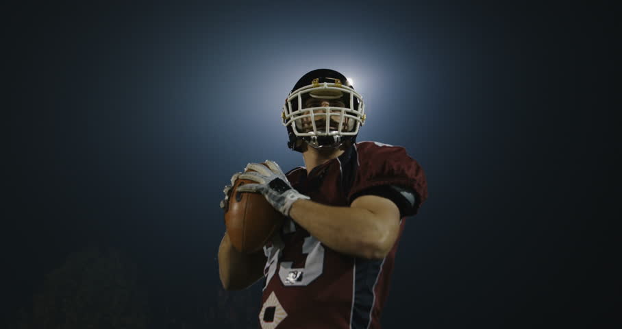 American footbal player practicing throwing and catching