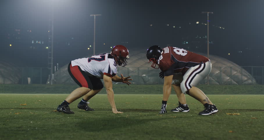 American football player tackles opponent Royalty-Free Stock Footage #1007511460