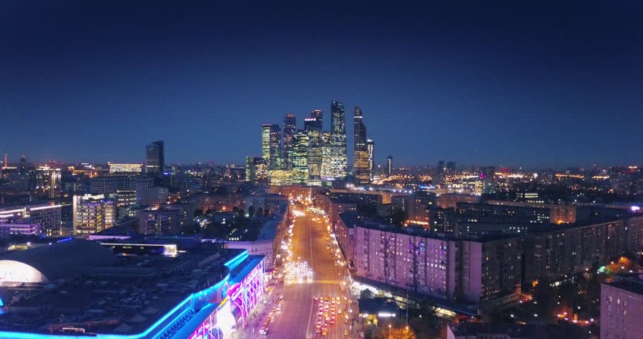 Aerial view of Moscow City skyline at night. Camera flying forward. Russia.