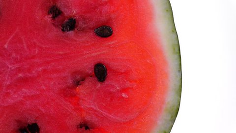 Juicy red watermelon rotates on white background with free place for your text in 4K. Refreshing and healthy tasty fruit. Top view. 스톡 비디오