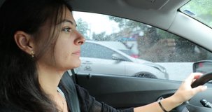 Young woman driving on road. 4K clip of 30 year old girl driver