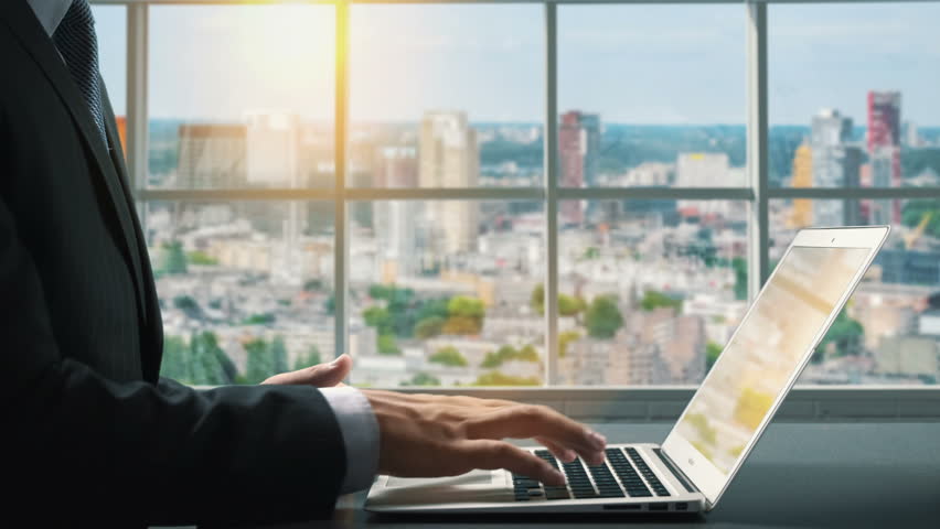 View of Rotterdam Netherlands.Close up hand Businessman using laptop