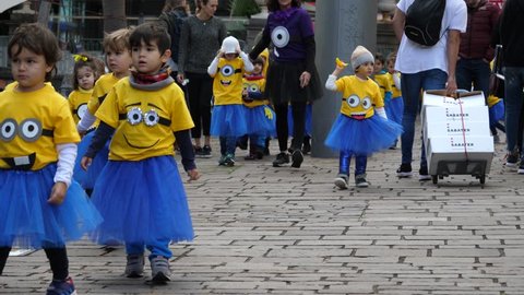SANTA CRUZ DE TENERIFE - FEB 08, 2018: Children group in funny costumes minions walking the street before carnival