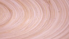 Amazing wood concave surface with laminated structure close up, rotating clockwise with side center. Vibrant natural texture with excellent details in UHD 4k, 3840x2160, clip. Cycle race track.