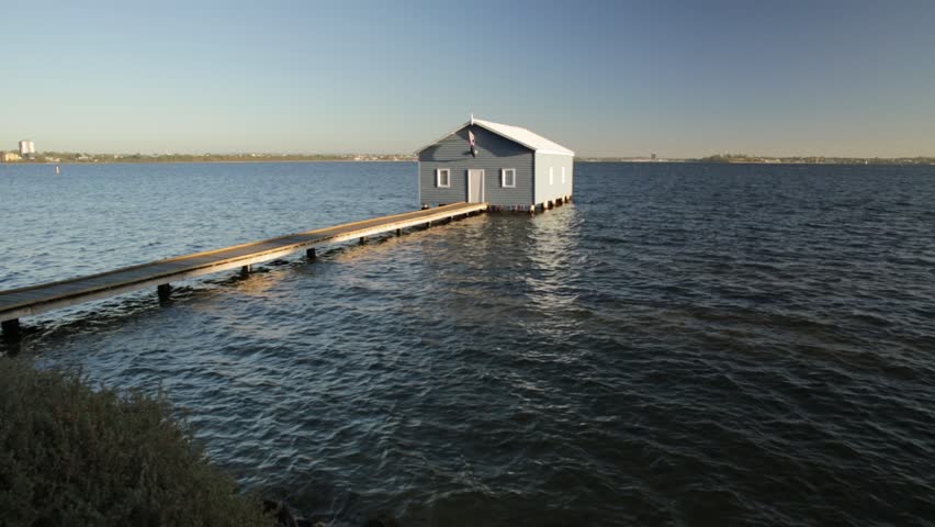The iconic landscape of Blue Boat House or Crawley Edge Boatshed with wooden jetty on Swan River at sunset light. One of the most photographed locations in Perth, Western Australia, near Kings Park.