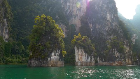 View from the water at the famous "Three Sisters" karst formations in Cheow Lan Lake inside Khao Sok National Park, Thailand