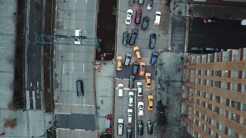 Traffic from aerial view above street zooming out; cars and taxis in gridlock congested lane New York City NYC 4K