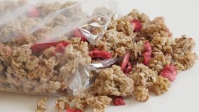 High quality crunchy cereals close-up 4K 2160p 30fps UltraHD footage - Panning on  muesli with dehydrated strawberries slow pan 3840X2160 UHD video