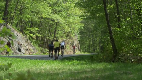 Gatineau Hills, Quebec Canada-May 17 2015: Beautiful Spring day,  cyclists riding up hill