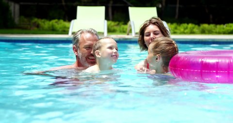 Happy family enjoying in swimming pool