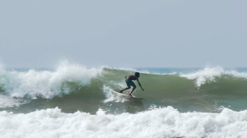 Footage of a surfer surfing in Weligama, Sri Lanka. Slowmotion shot in 4k.