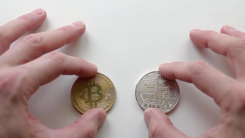 Hands play with Gold and Silver Bitcoins, Sign of Internet money on white background. Online income opportunity
