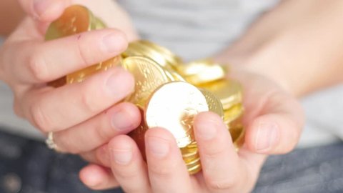golden coins in hands