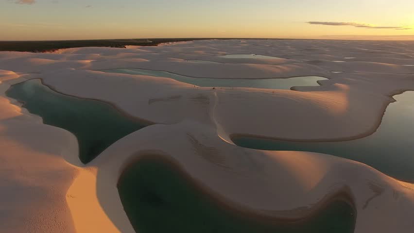 Aerial view of dunes and rainwater lakes at Lençóis Maranhenses National Park, Barreirinhas, Maranhão, Brazil Northeast Coast Royalty-Free Stock Footage #1007591008
