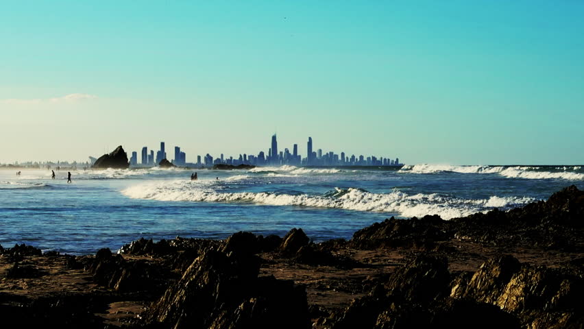 Elephant Rock, Currumbin Beach looking over the ocean with the city of Surfers Paradise, Gold Coast, Australia in the distance. An Eye Level Extreme Long Shot.