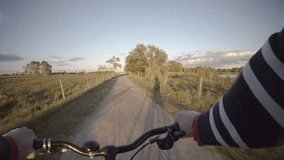 Riding bike on rural road pov film clip. Leisure and recreation in swedish countryside.