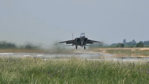 Military Combat Jet Aircraft Retracts the Landing Gear while Takeoff in Slow Motion 96fps. United States Air Force McDonnell Douglas F-15C Eagle at Graf Ignatievo (Plovdiv) Air Base 24 June 2016