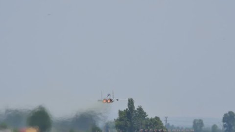 Military Combat Jet Aircraft Pull Up in Candle just after Takeoff with Full Afterburner in Slow Motion. United States Air Force McDonnell Douglas F15 Eagle Boeing at Plovdiv Air Base 24 June 2016