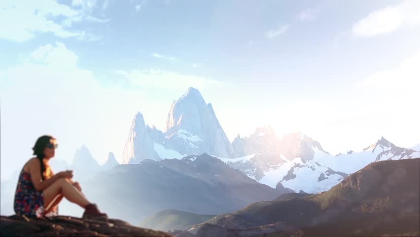 A Blurred Woman Drinking Mate with the Mount Fitz Roy in the Background, Los Glaciares National Park, Santa Cruz province, Argentina, South America. 
